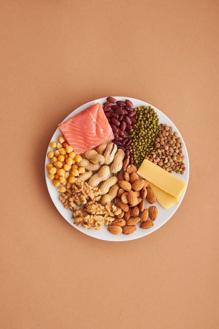 Colorful assortment of proteins and legumes on a white plate, perfect for healthy eating inspiration.